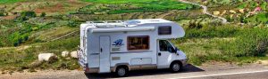 Motorhome parked next to mountain